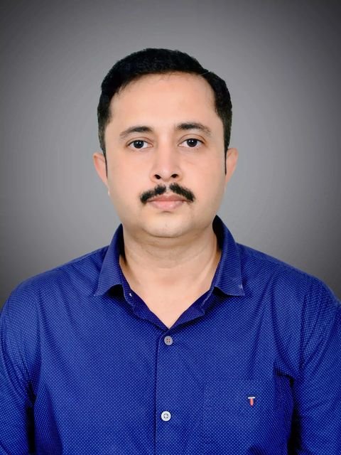 Dr. Kumar Vivek in a blue shirt