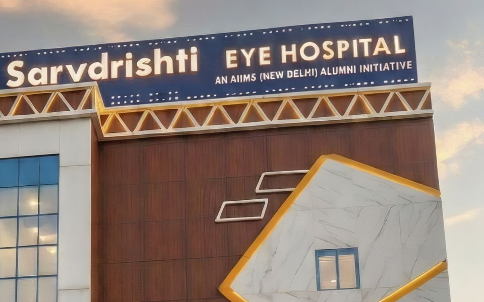 The lit sign of Sarvdrishti Eye Hospital, Patna, at dusk